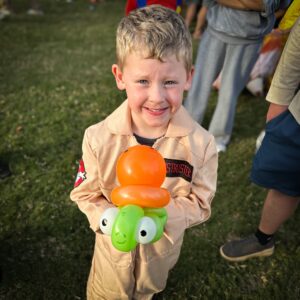 Happy Boy Holding a Turtle Balloon